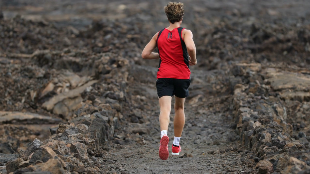 running-man-in-trail-runner-cross-country-run-living-healthy-sport-lifestyle-jogging-male-athlete-working-out-as-part-of-healthy-lifestyle-rear-view-showing-back-from-behind-on-big-island-hawaii_r.png